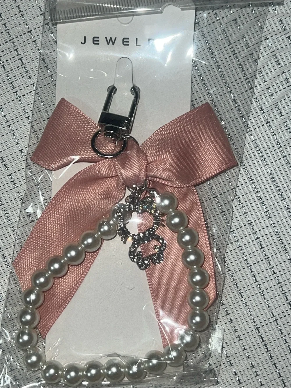 coquette-style pink satin bow and pearl wristlet keychain
